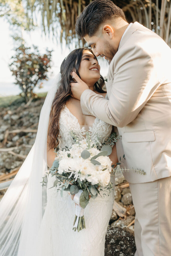 bride and groom take wedding portraits at kualoa ranch in oahu