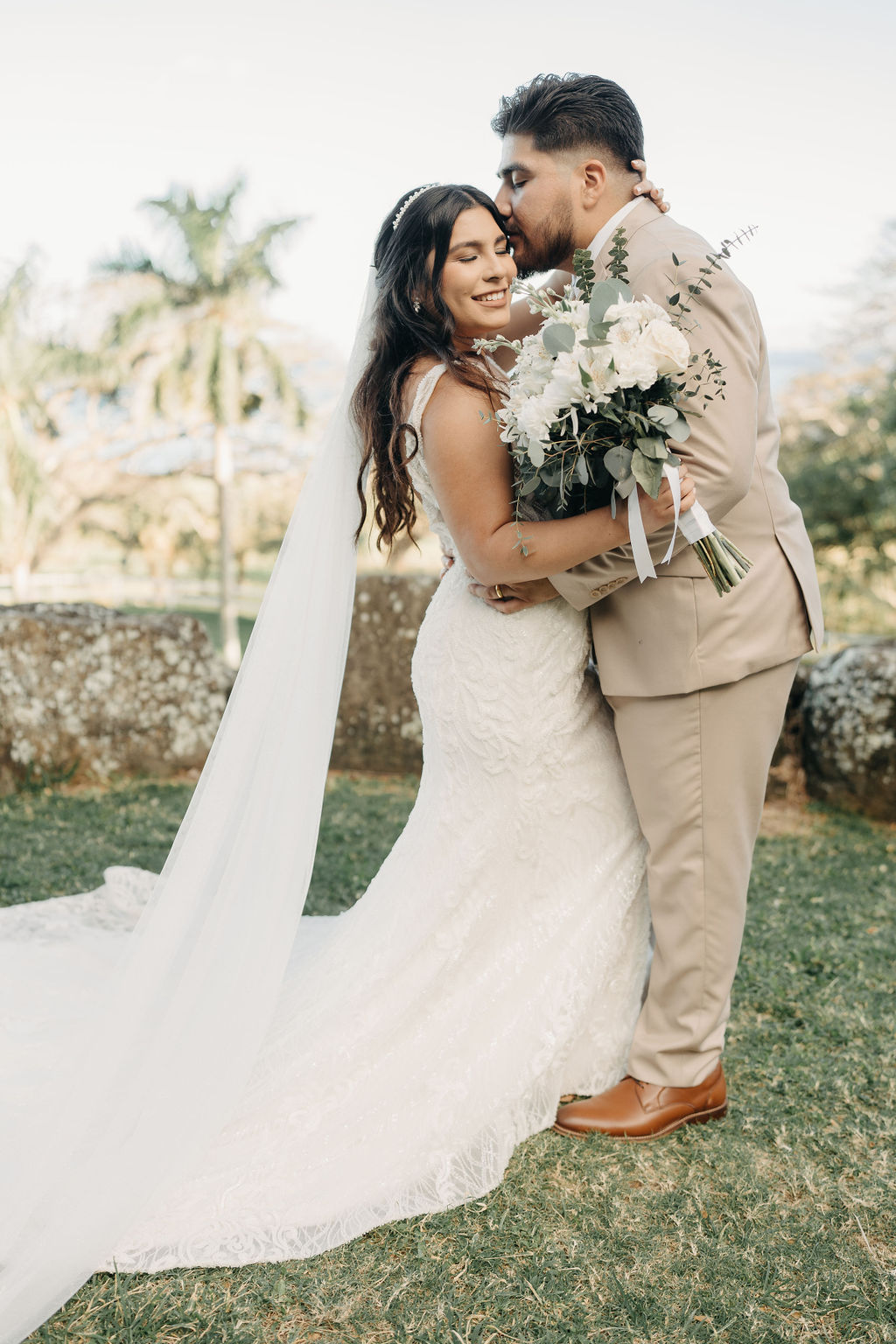 bride and groom take wedding portraits at kualoa ranch in oahu 