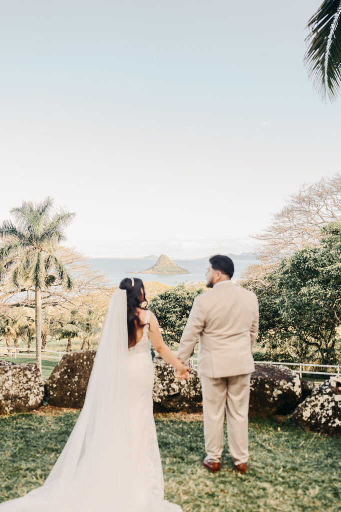 bride and groom take wedding portraits at kualoa ranch in oahu