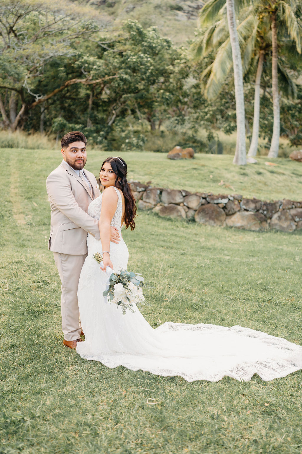 bride and groom take wedding portraits at kualoa ranch in oahu