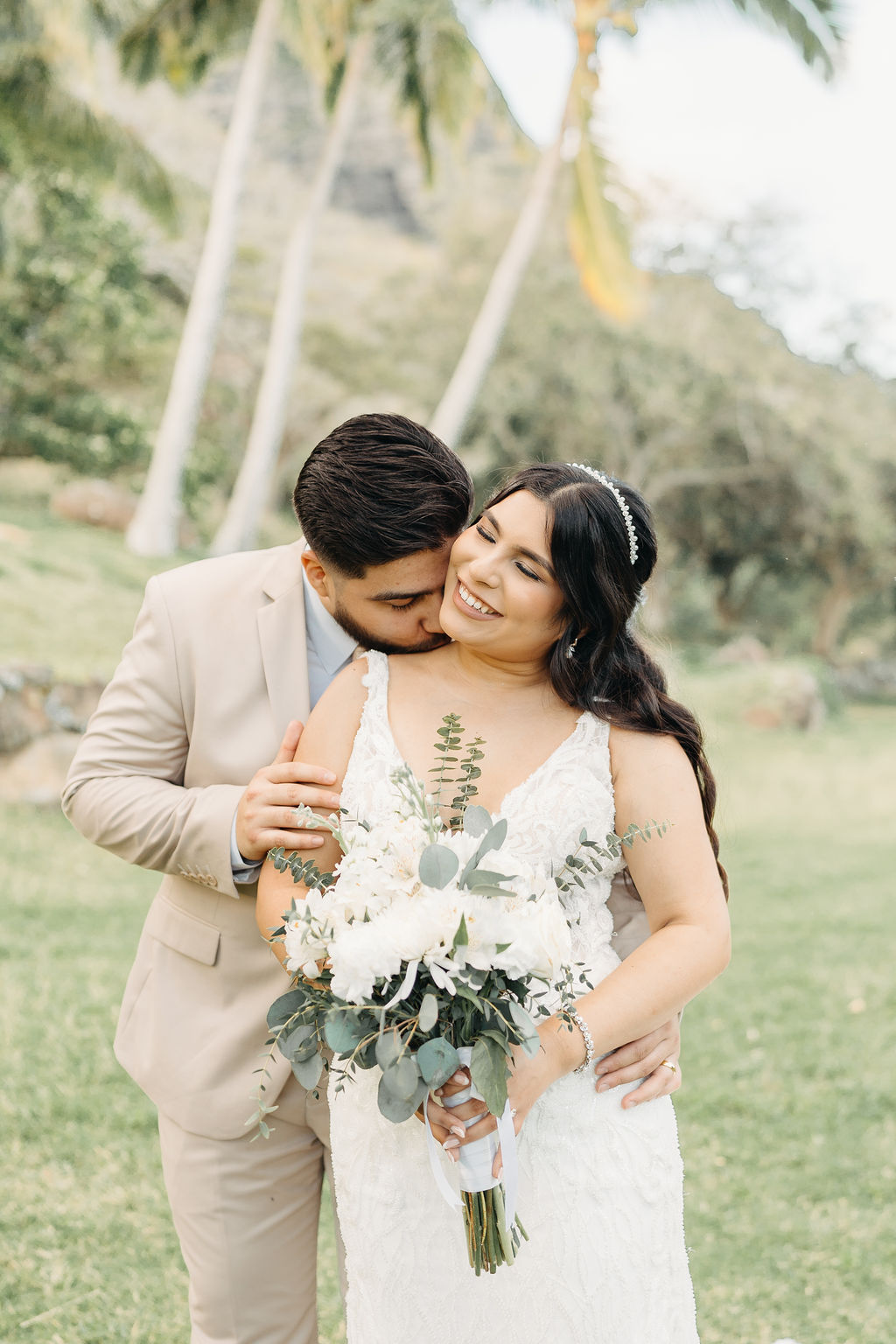 bride and groom take wedding portraits at kualoa ranch in oahu