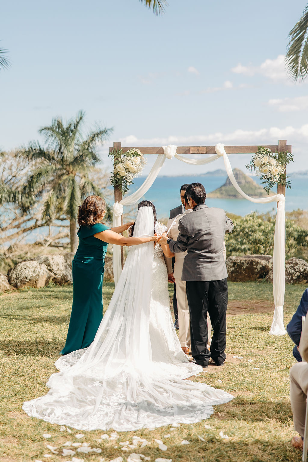 bride and groom at their wedding ceremony at kualoa ranch