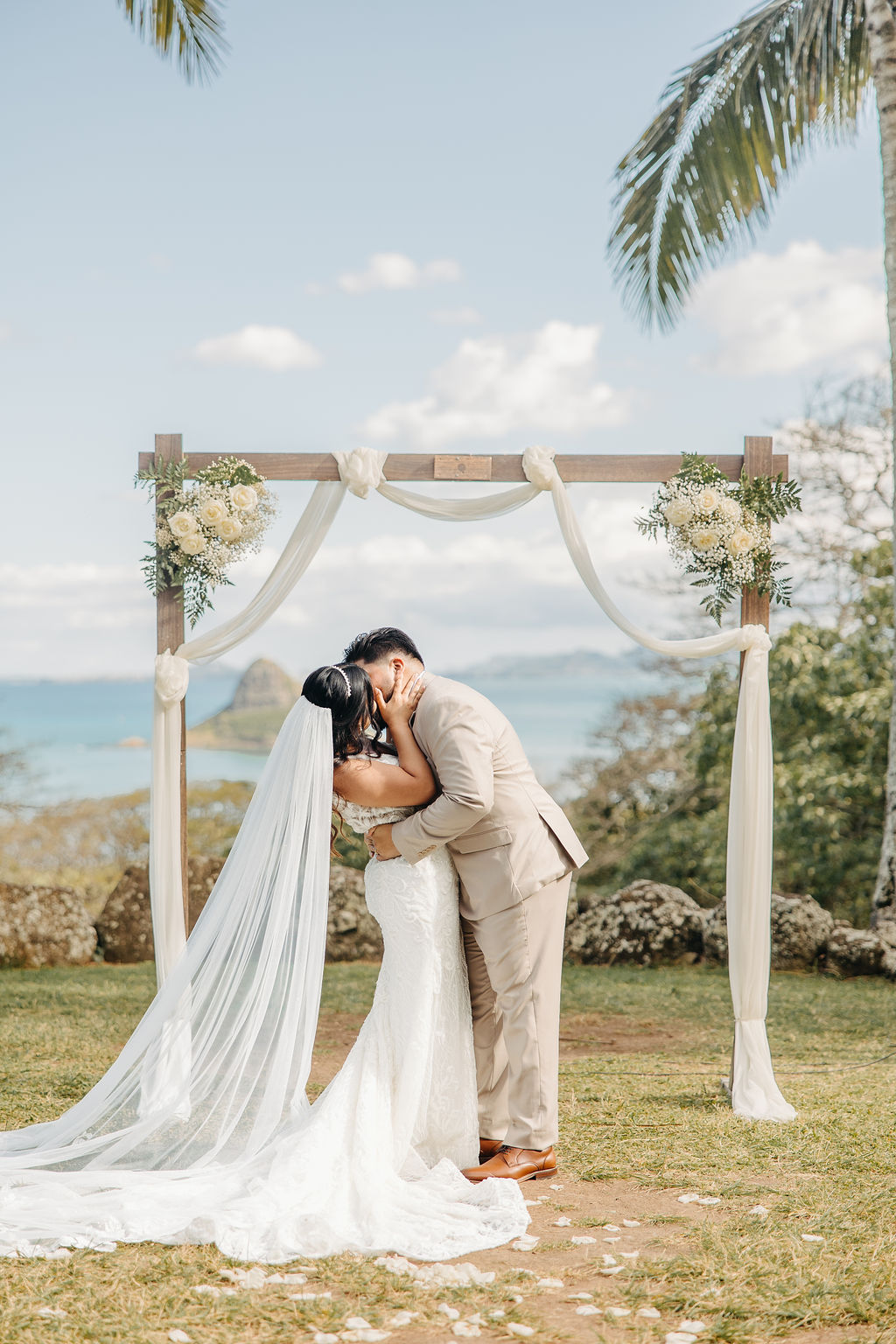 bride and groom at their wedding ceremony at kualoa ranch