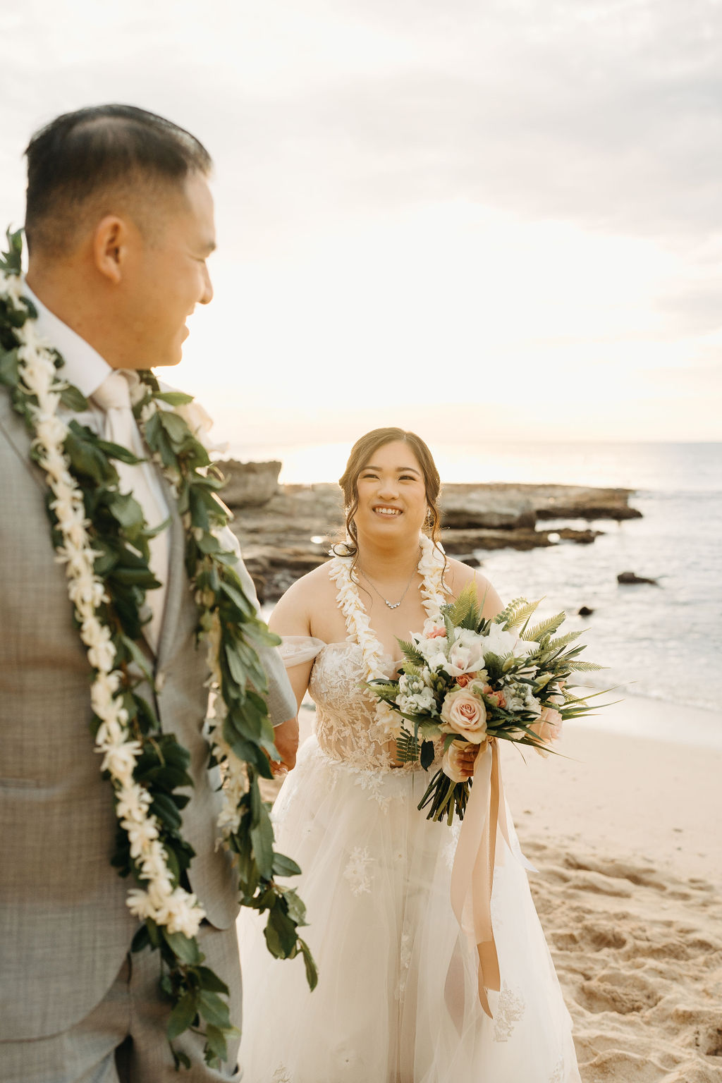 Bride and groom take wedding portraits at Lanikuhonua Cultural Institute