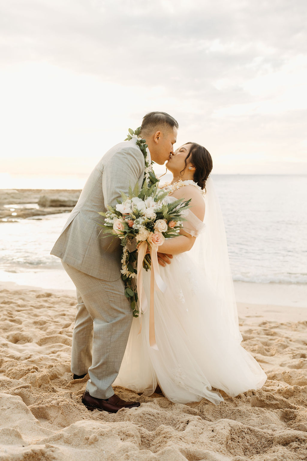 Bride and groom take wedding portraits at Lanikuhonua Cultural Institute