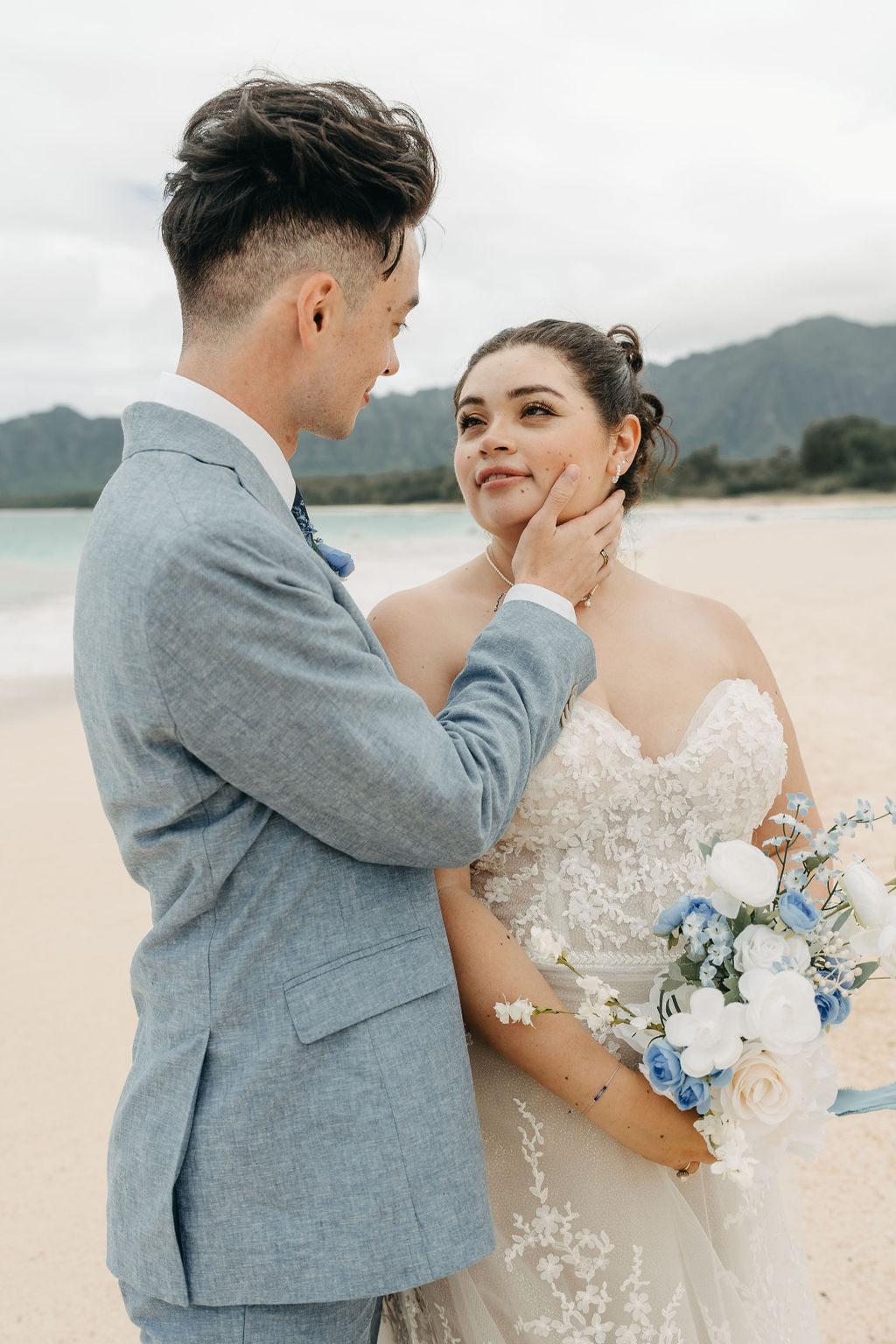 bride and groom take wedding portraits on the beach for their beach wedding in Oahu