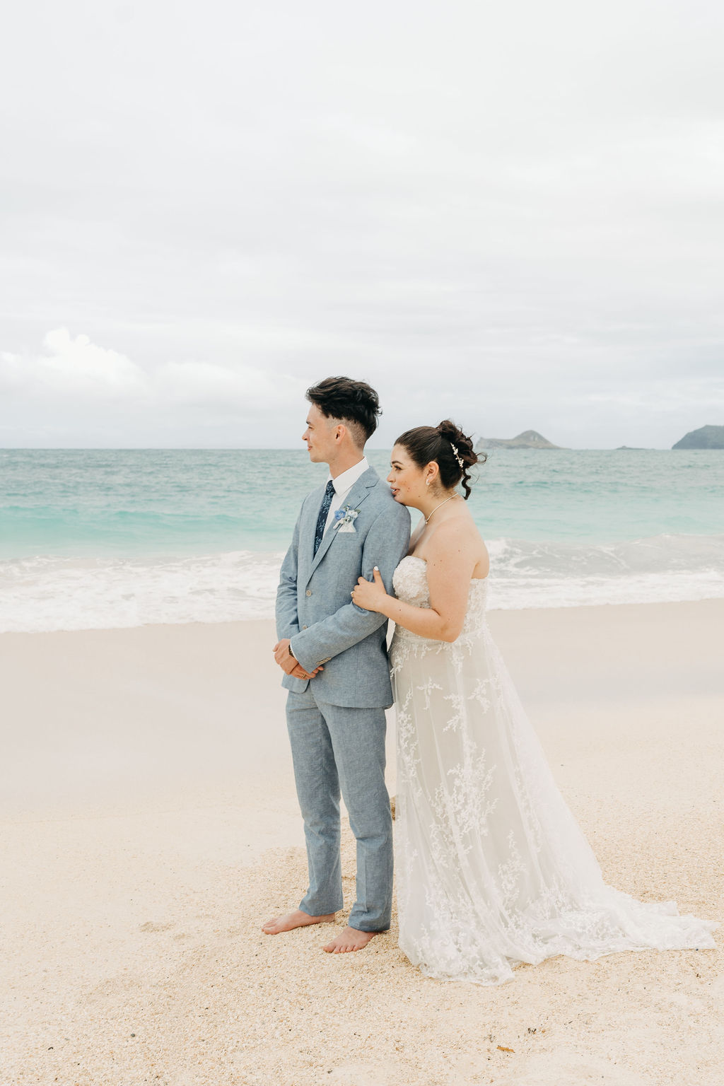 bride and groom take wedding portraits on the beach for their beach wedding in Oahu