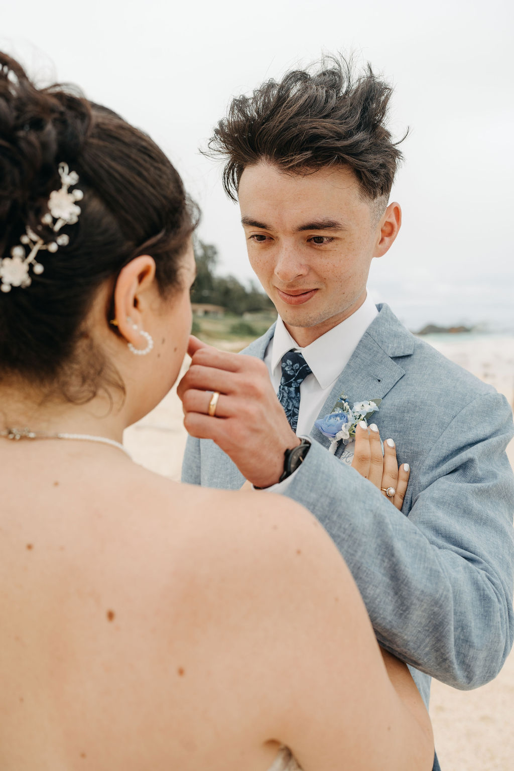 bride and groom take wedding portraits on the beach for their beach wedding in Oahu