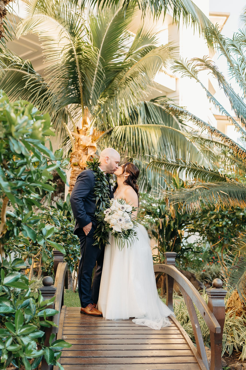 bride and groom take sunset portraits for the wedding at the four seasons in oahu