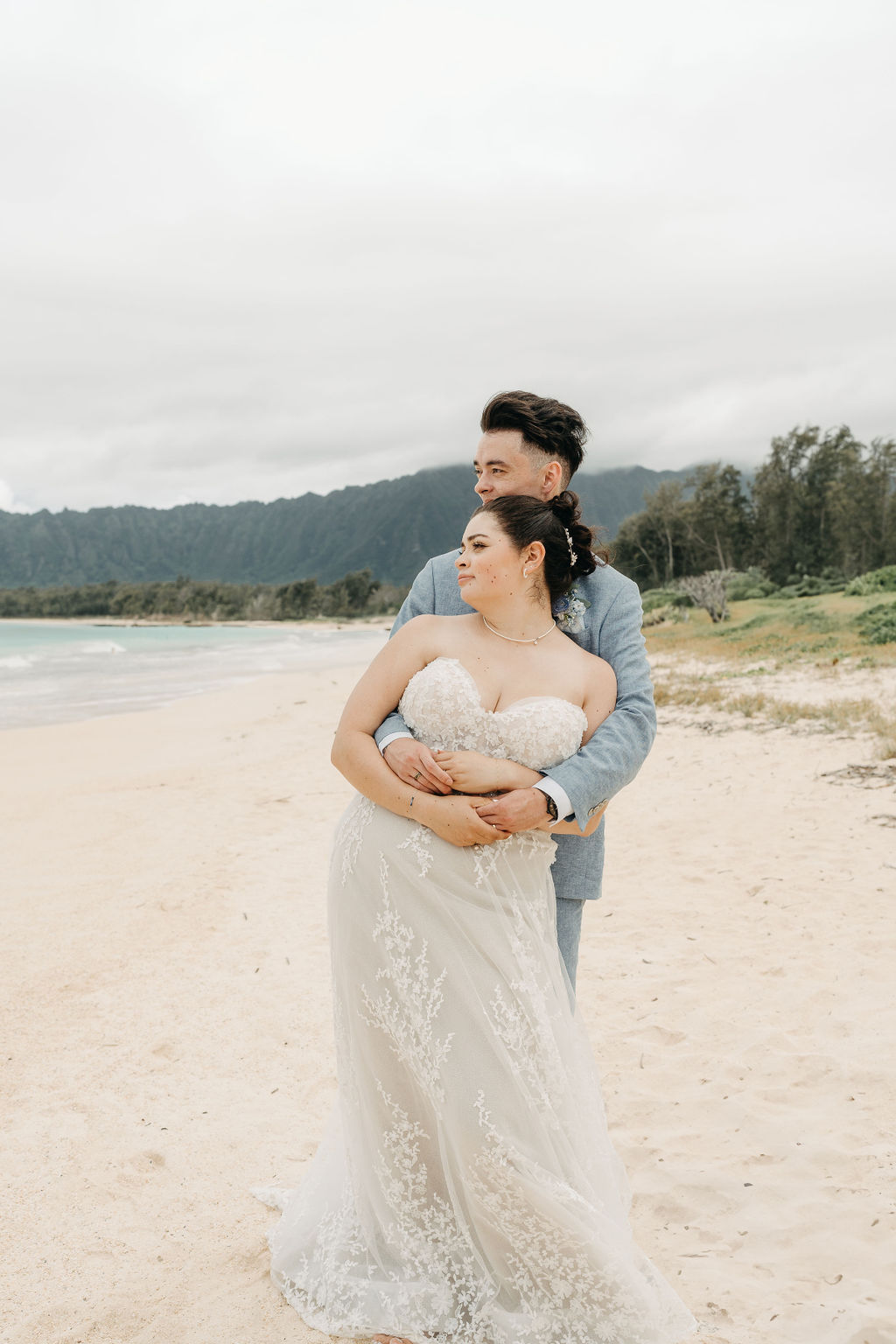 bride and groom take wedding portraits on the beach for their beach wedding in Oahu