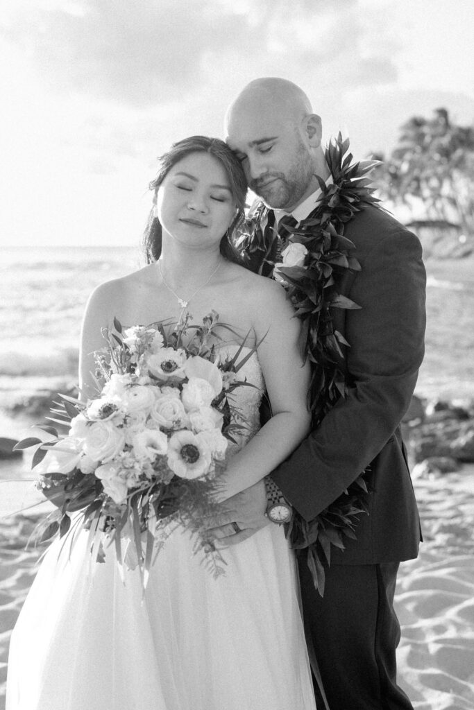 bride and groom take sunset portraits for the wedding at the four seasons in oahu