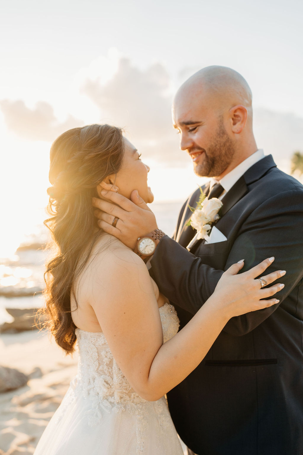 bride and groom take sunset portraits for the wedding at the four seasons in oahu