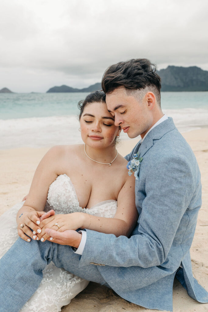 bride and groom take wedding portraits on the beach for their beach wedding in Oahu