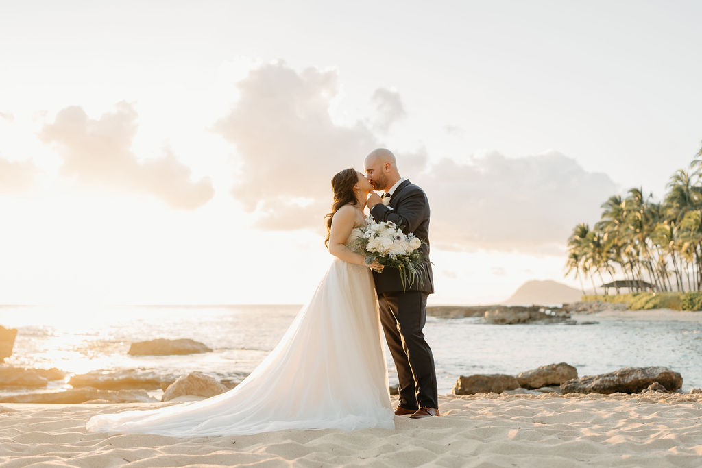 bride and groom take sunset portraits for the wedding at the four seasons in oahu