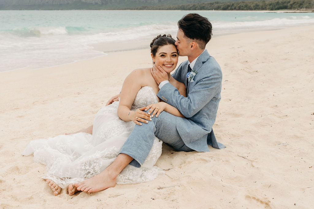 bride and groom take wedding portraits on the beach for their beach wedding in Oahu