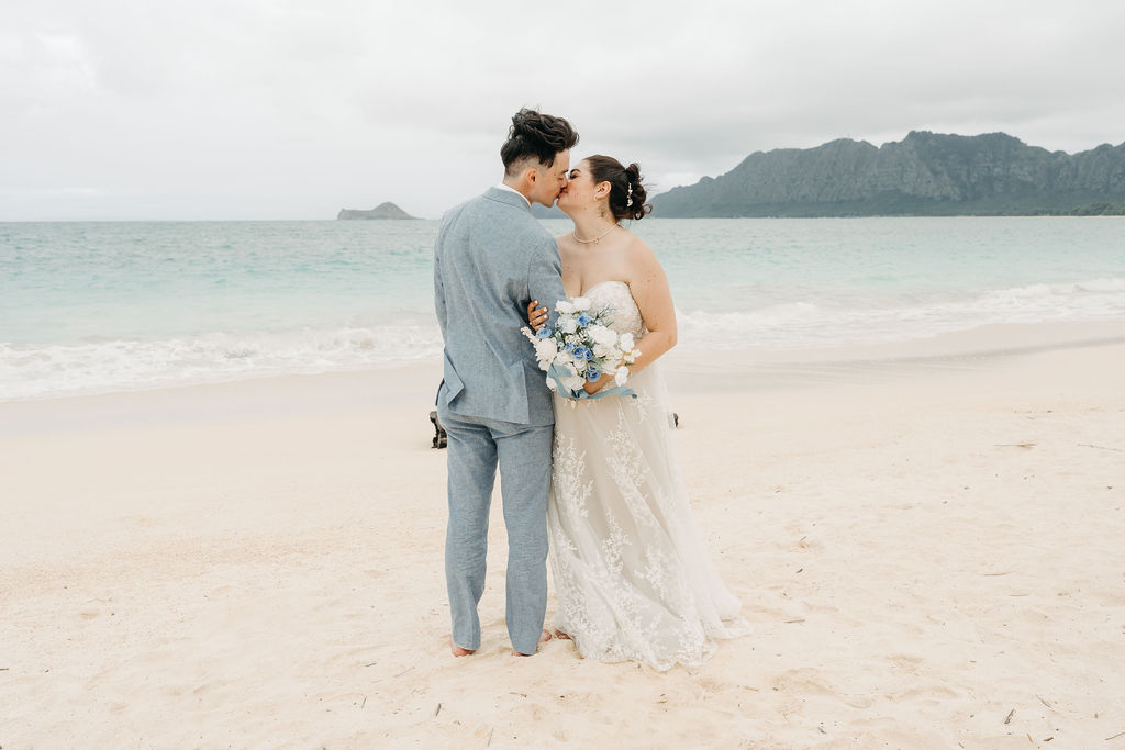 bride and groom take wedding portraits on the beach for their beach wedding in Oahu