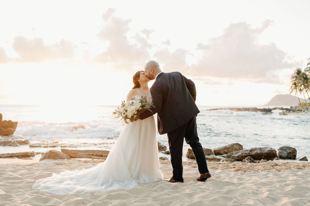 bride and groom take sunset portraits for the wedding at the four seasons in oahu