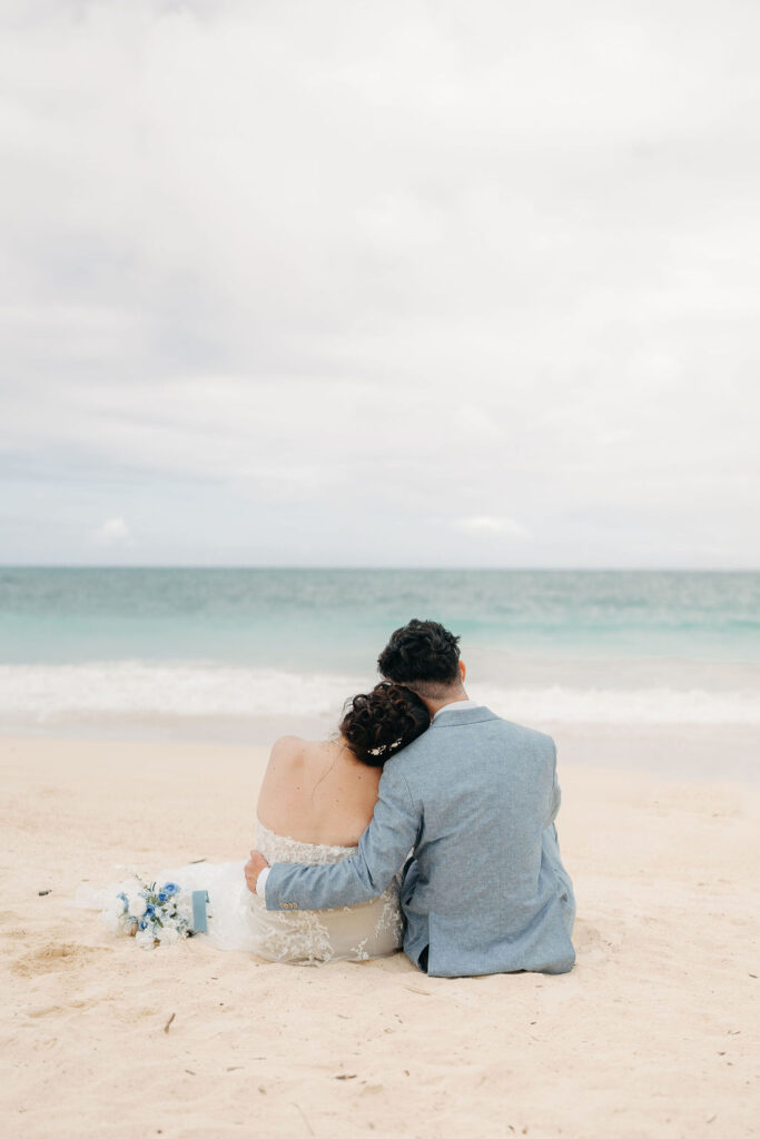 bride and groom take wedding portraits on the beach for their beach wedding in Oahu