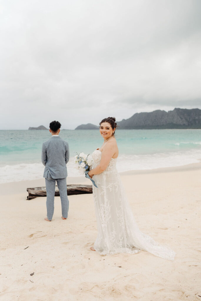 bride and groom take wedding portraits on the beach for their beach wedding in Oahu