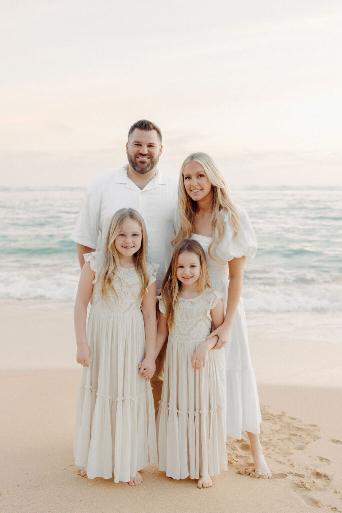 family taking family photos on their family vacation to Oahu