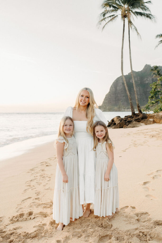 family taking family photos on their family vacation to Oahu