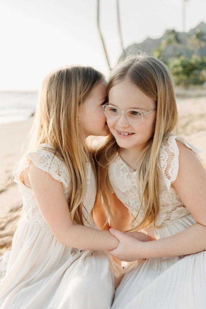 family taking family photos on the beach while their family vacation to Oahu