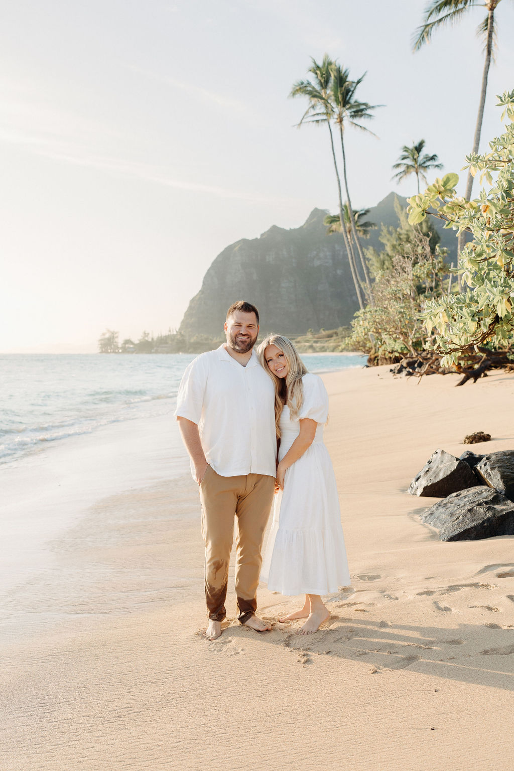 family taking family photos on the beach while their family vacation to Oahu