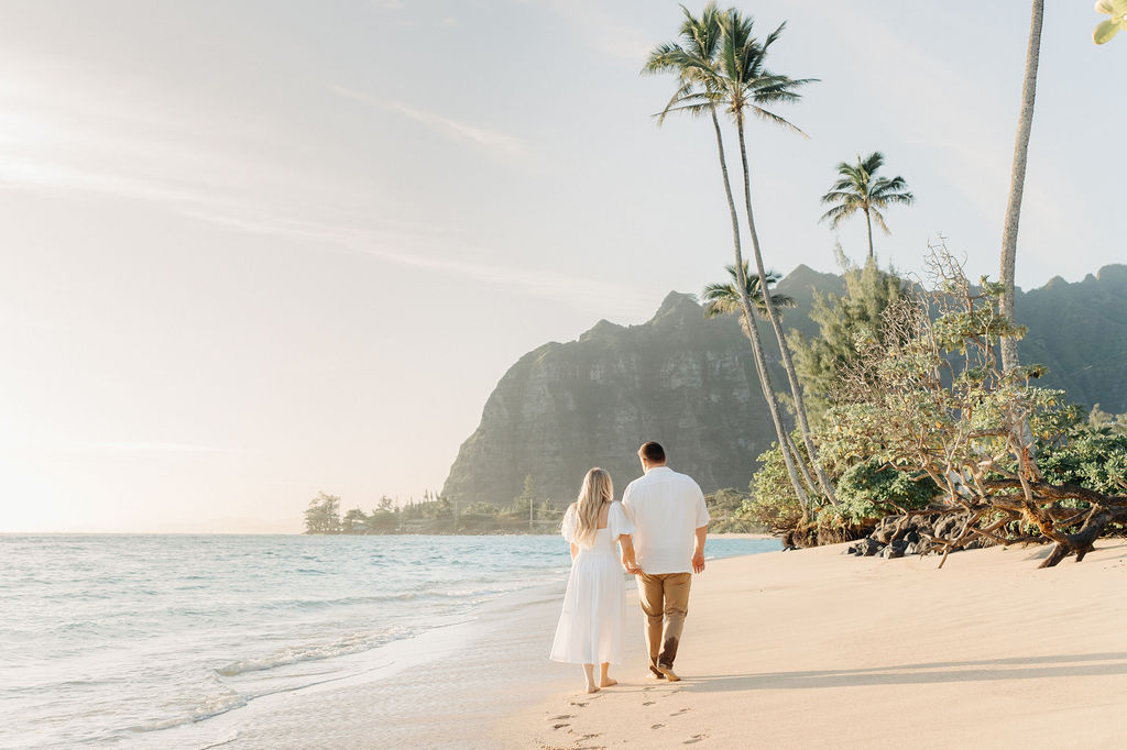 family taking family photos on the beach while their family vacation to Oahu