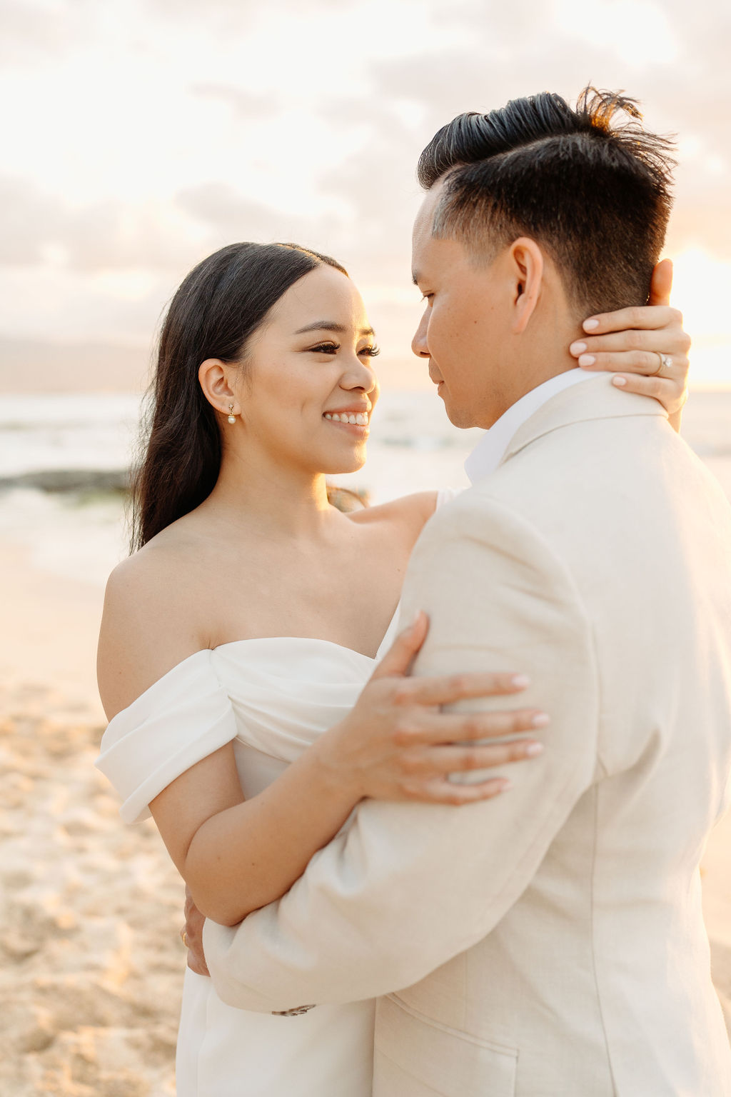 couple takes wedding portraits on a beach in oahu for their beach wedding ceremony