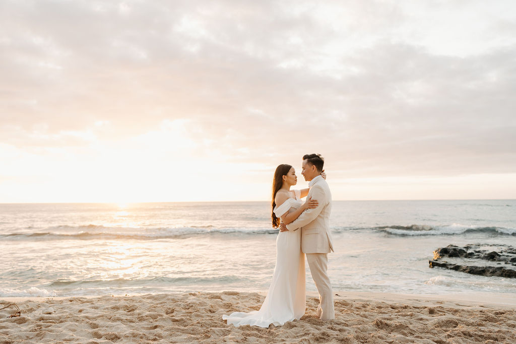 couple takes wedding portraits on a beach in oahu for their beach wedding ceremony