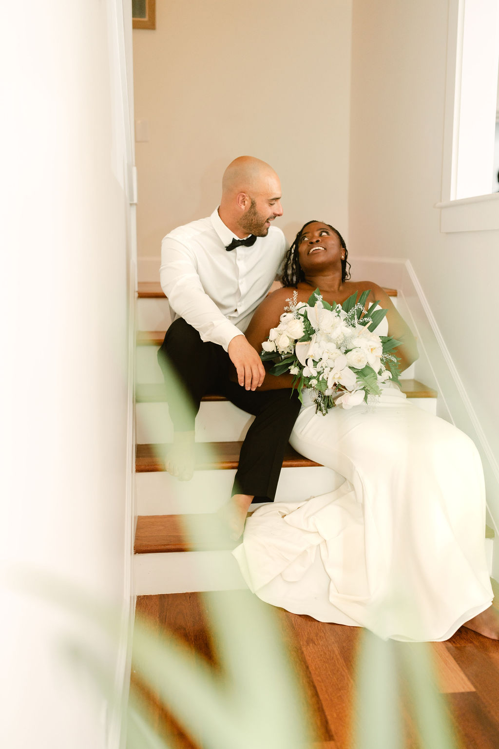 bride and groom taking wedding portraits on steps