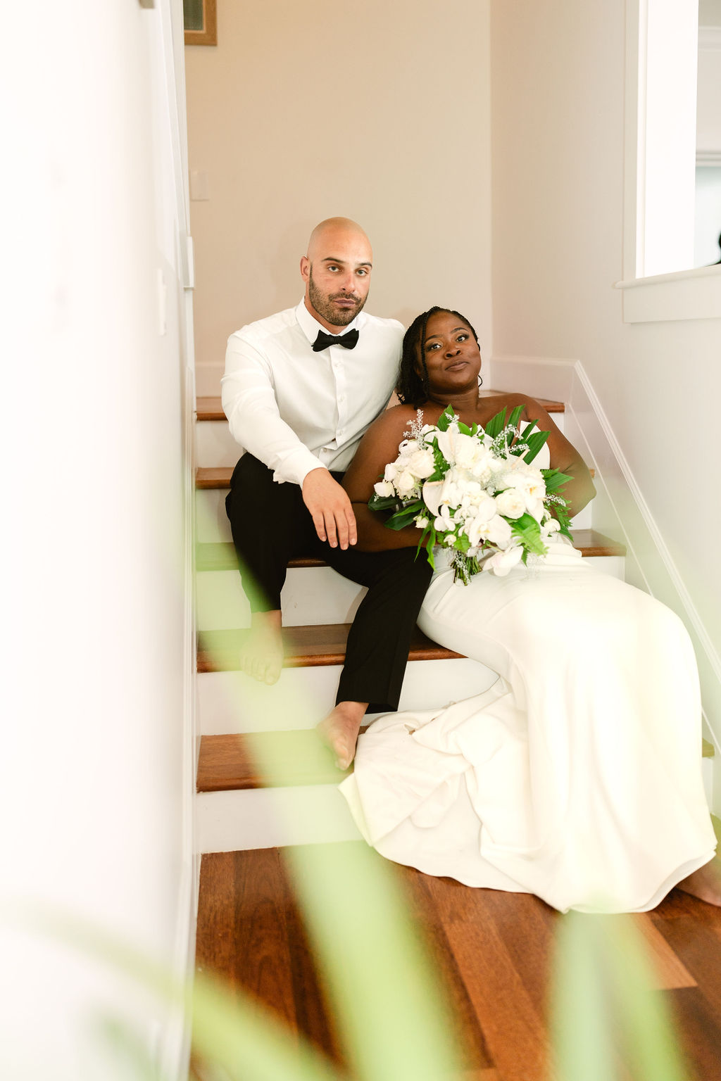 bride and groom taking wedding portraits on steps