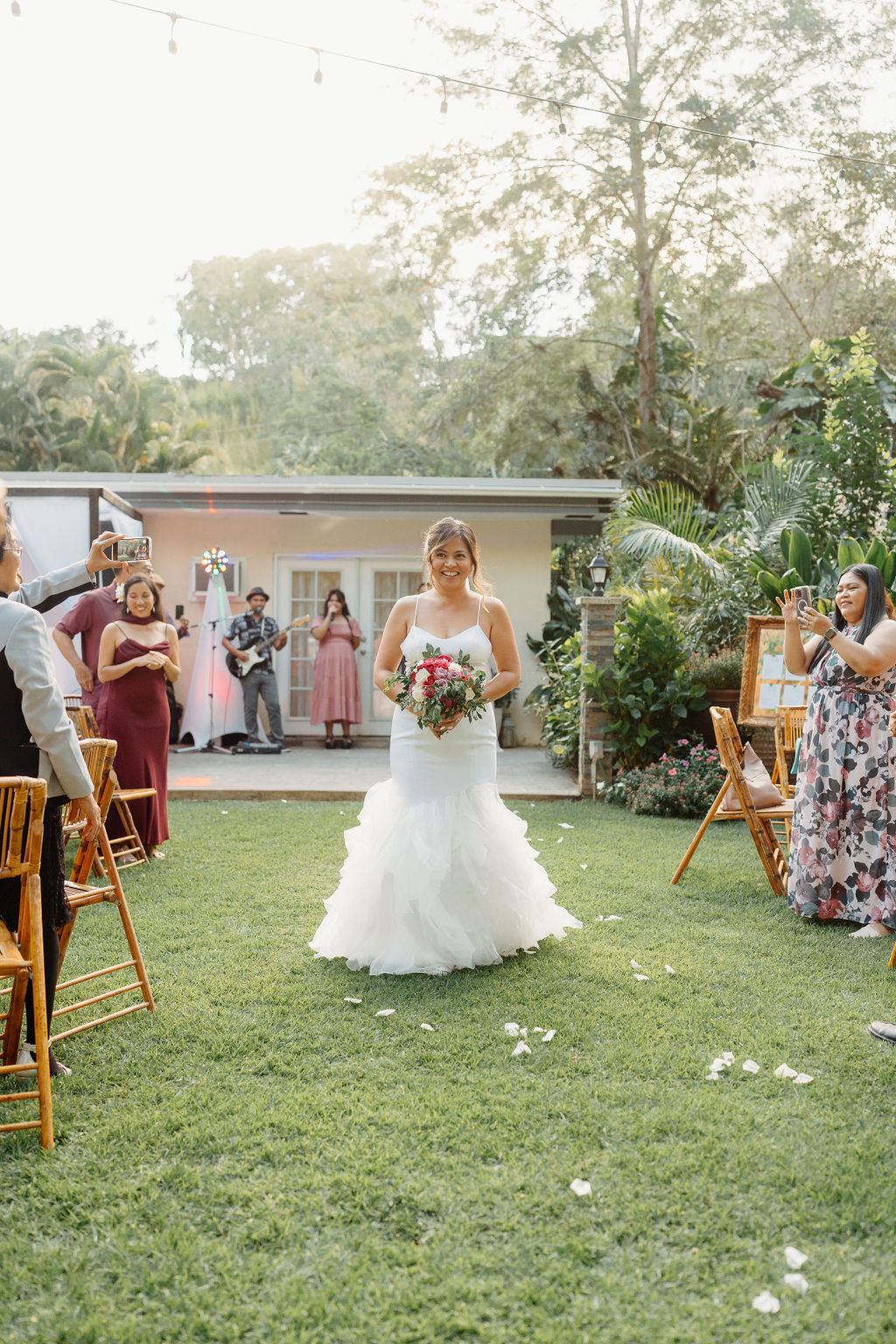 outdoor Backyard wedding ceremony in Oahu bride walks down the aisle