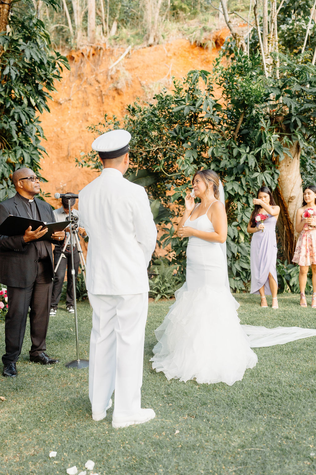 outdoor Backyard wedding ceremony in Oahu, couple stands at the end of the aisle