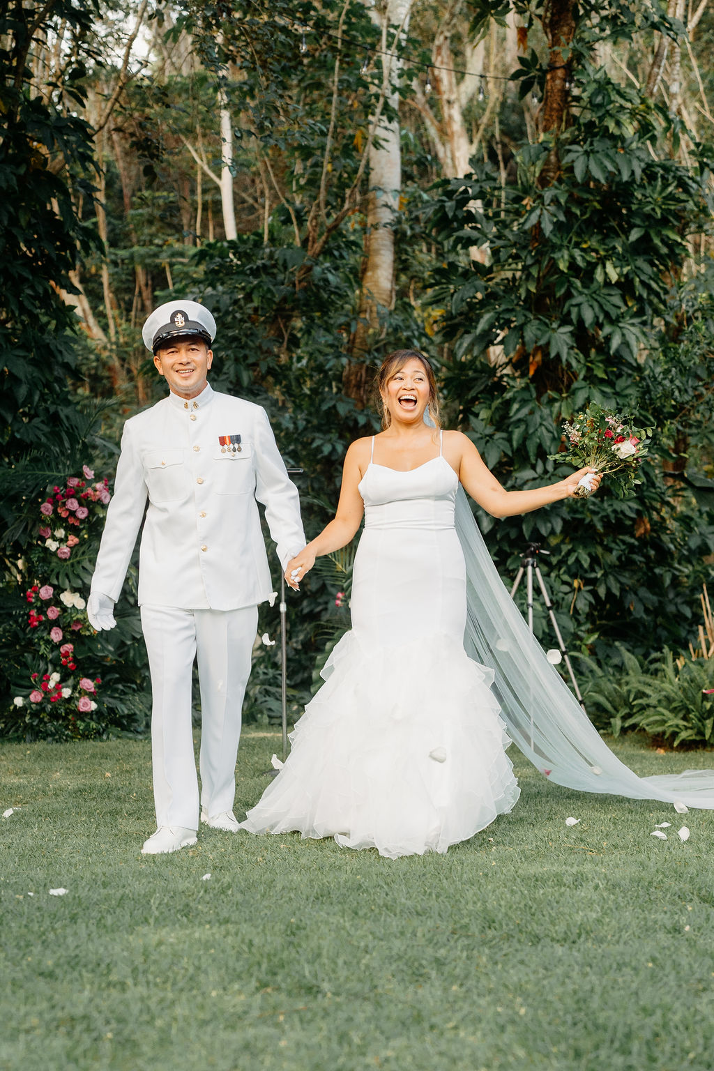 outdoor Backyard wedding ceremony in Oahu, couple stands at the end of the aisle