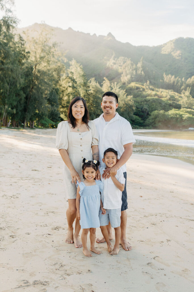 family takes fun photos on the beach for their oahu family portraits