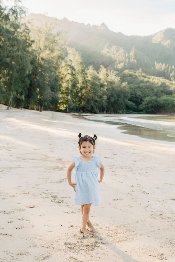 family takes fun photos on the beach for their oahu family portraits