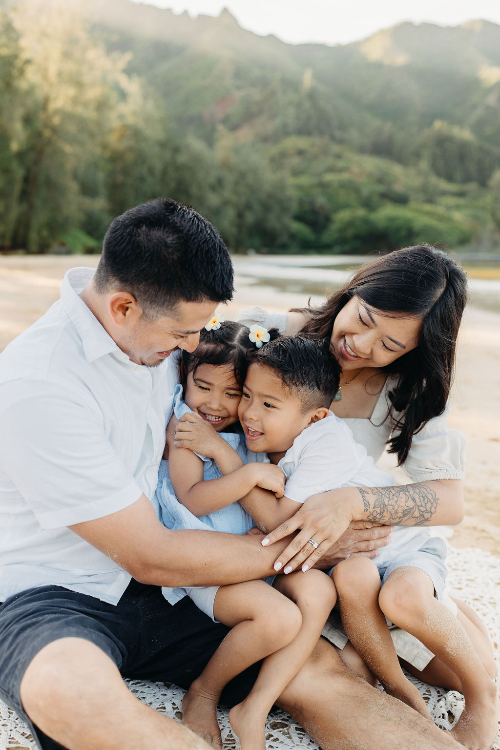 family takes fun photos on the beach for their oahu family portraits